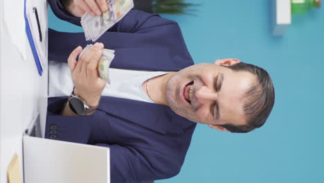 Vertical-video-of-Businessman-counting-money-looking-at-camera.